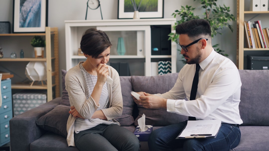 Rental owner sits at a desk looking stressed, with a pile of documents and a set of house keys in front of them, symbolizi...