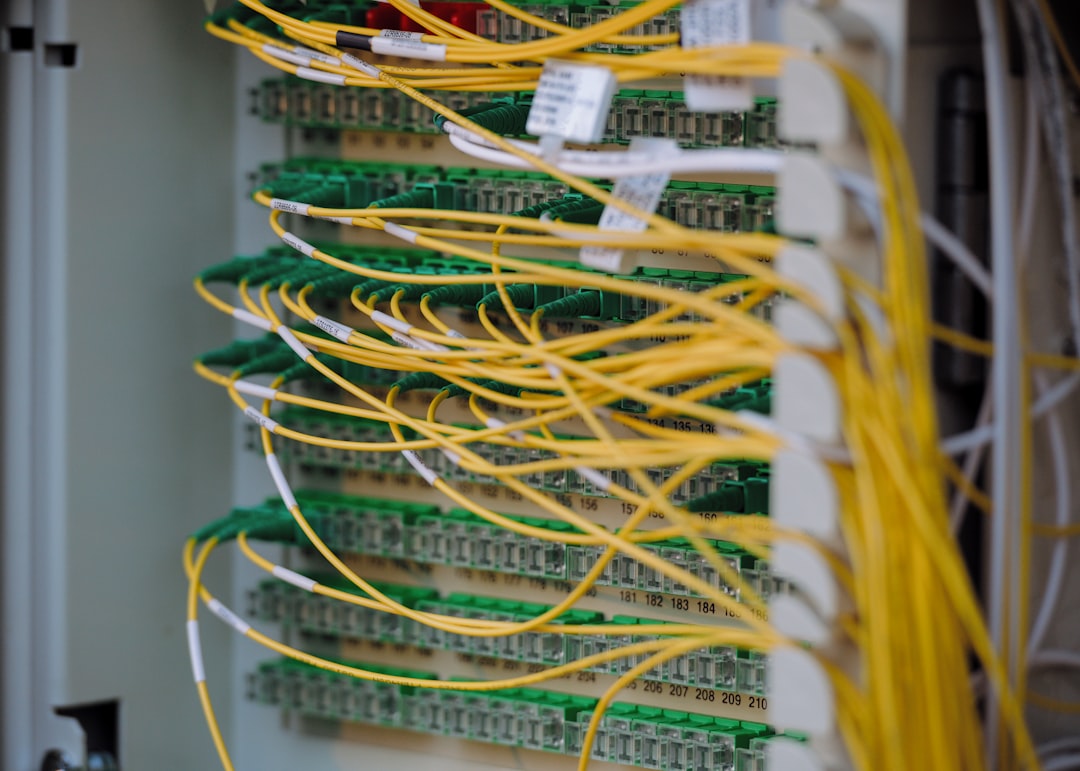 An interior view of a secure, modern data center with rows of server racks and cool-toned lighting, representing digital data protection and infrastructure.